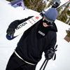 Faction freestyle skier walking wearing Faction Hoodie