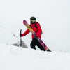 Freeride skier walking with yellow and purple powder and freeride Faction Studio 4 ski 2026